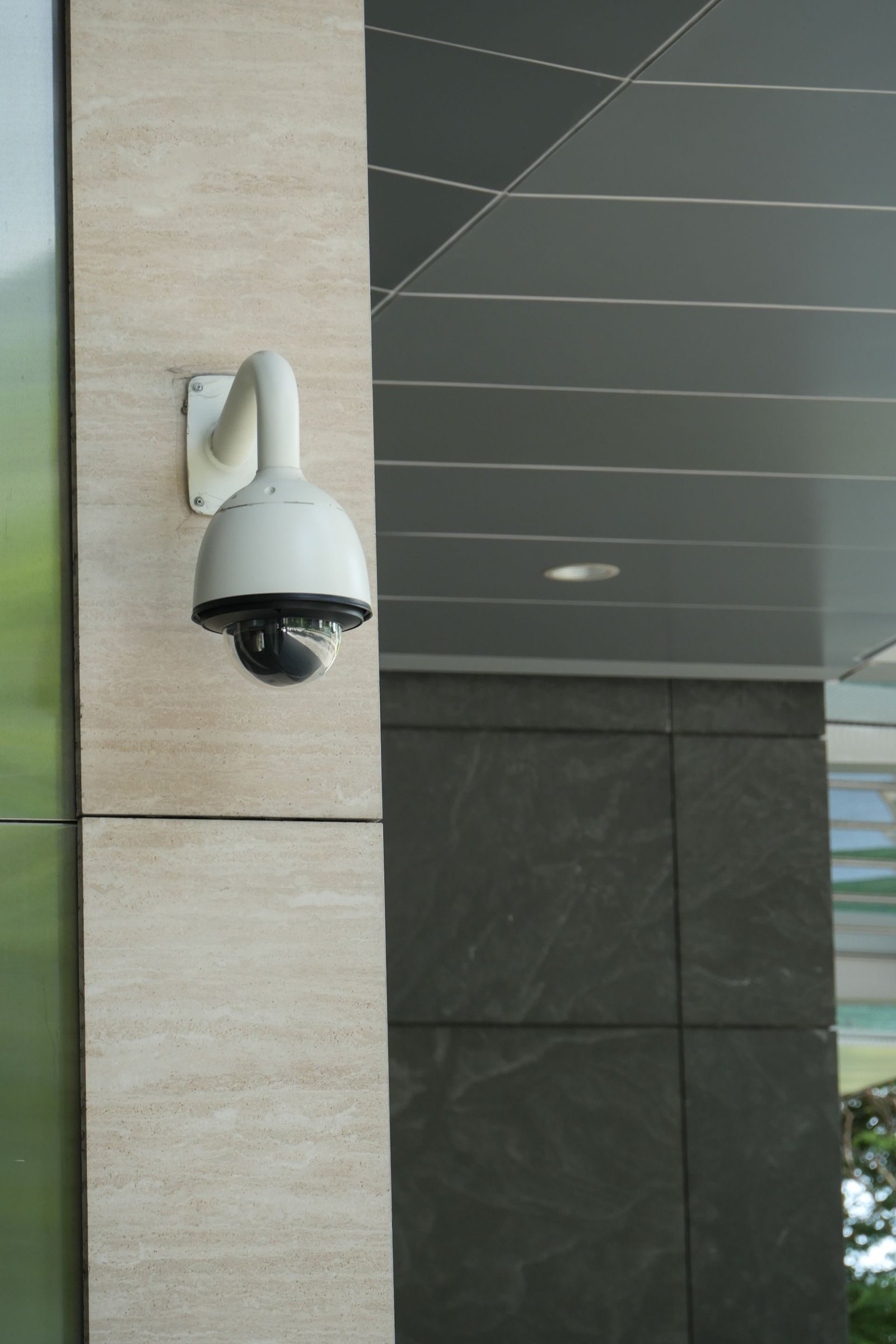 A dome security camera mounted under a roof eave