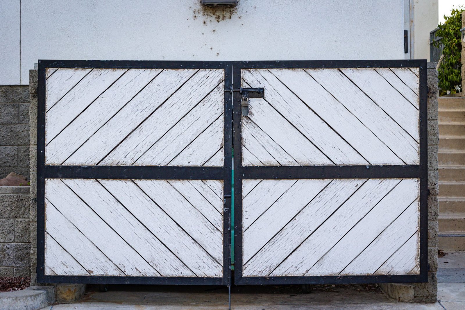 A two-leaf metal swing gate at an entrance