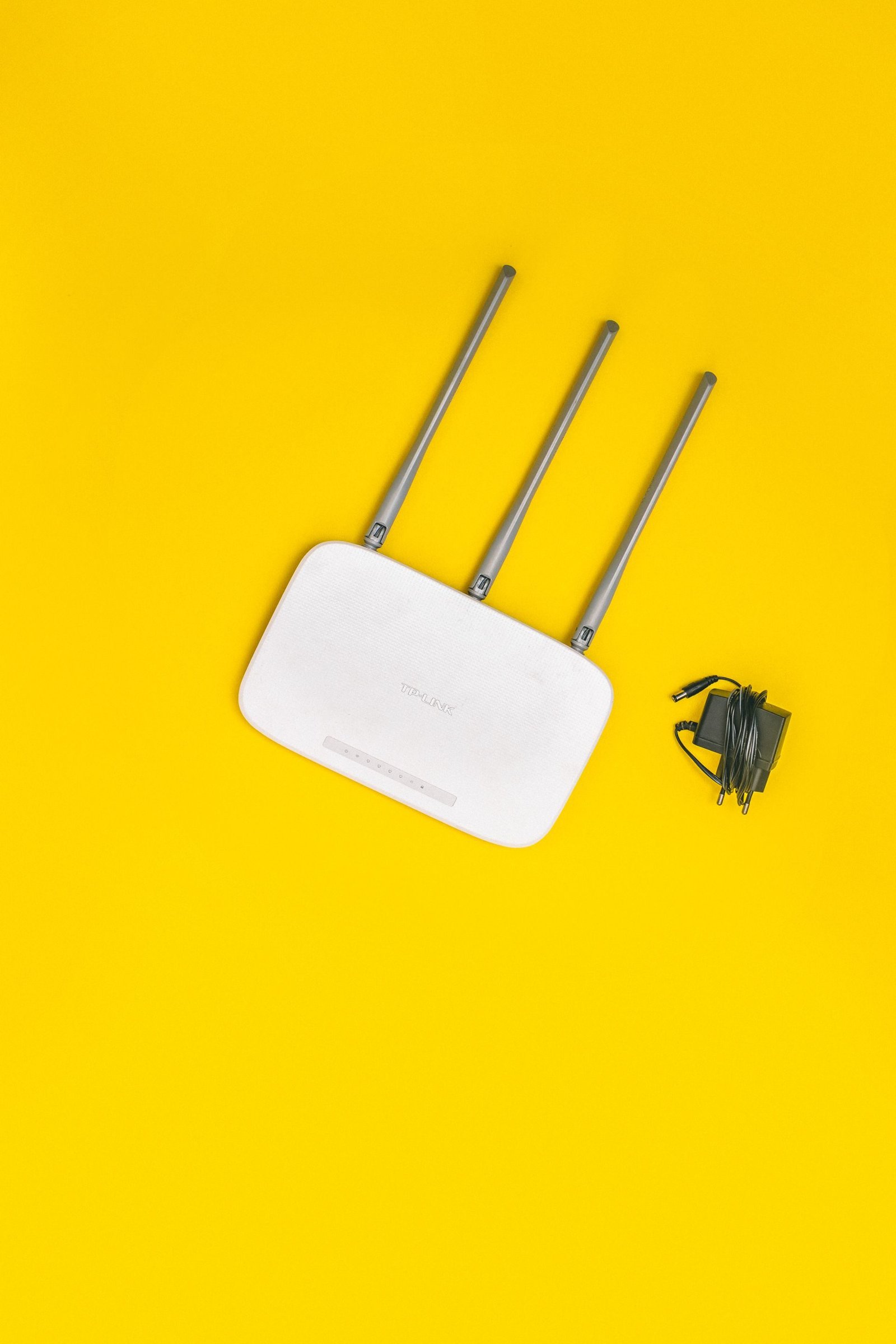 A white Wi-Fi router with antennas