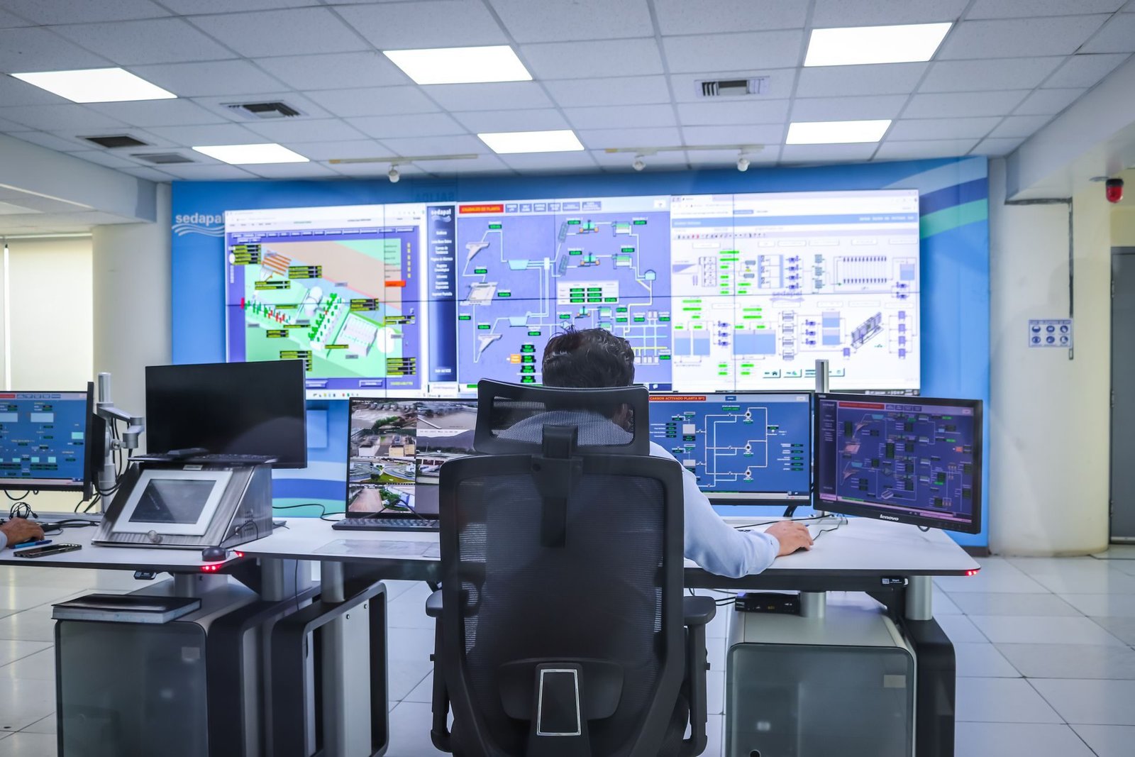 A monitoring desk with several screens showing camera feeds