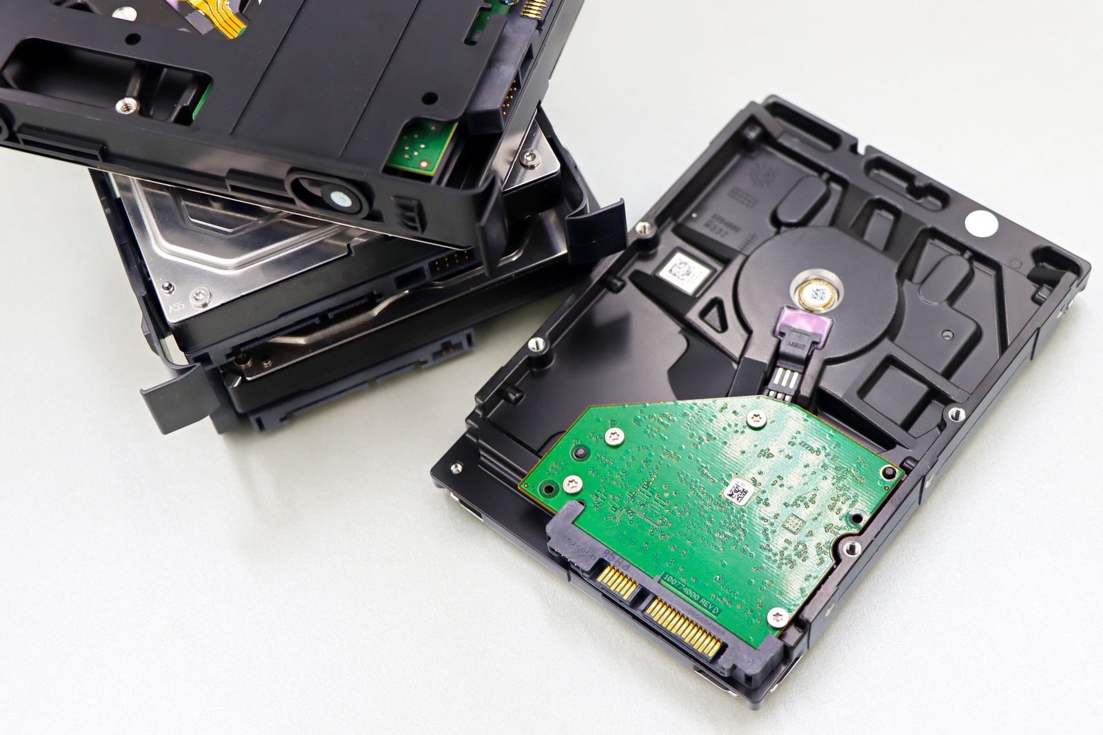 Opened hard disk drives showing their platters and circuit boards