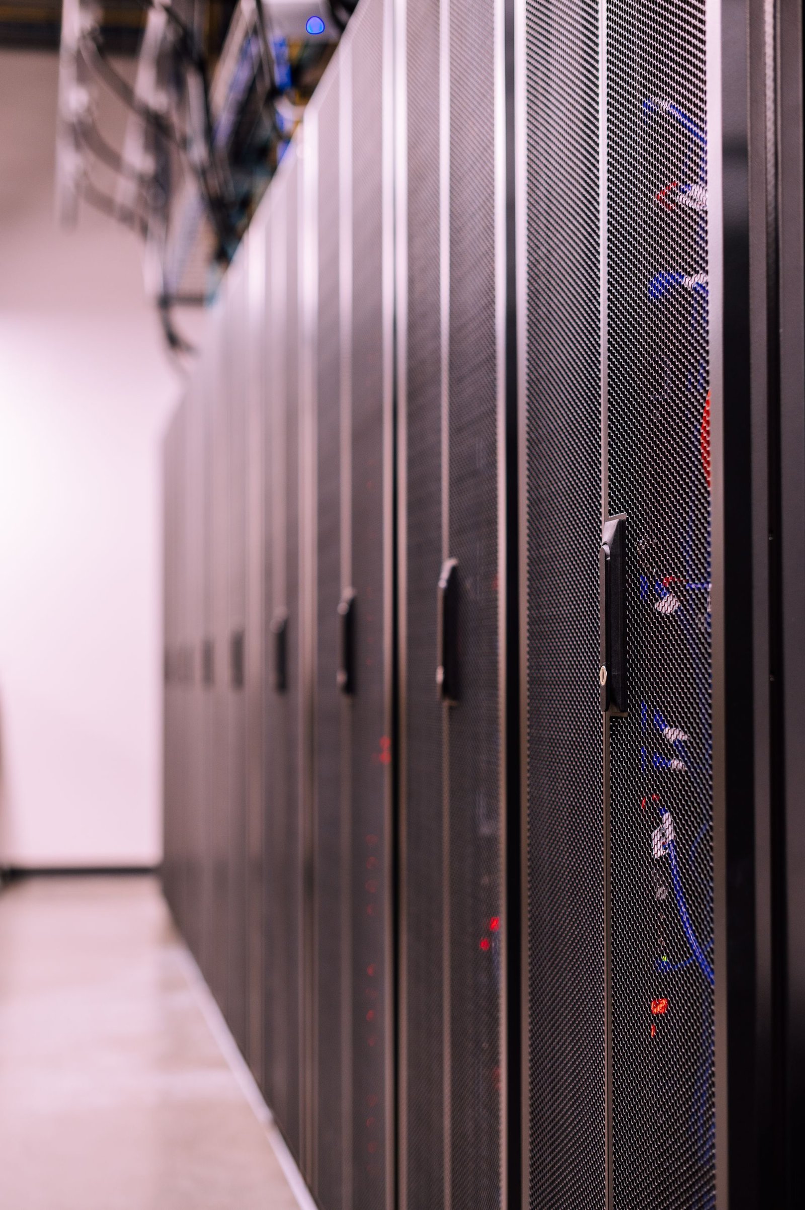 An aisle between server racks in a data centre