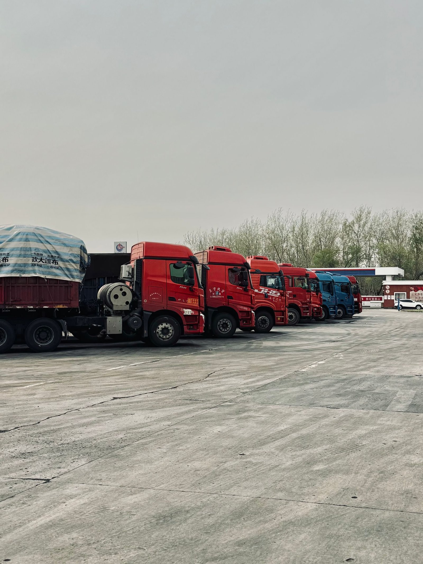 A row of trucks parked at a depot