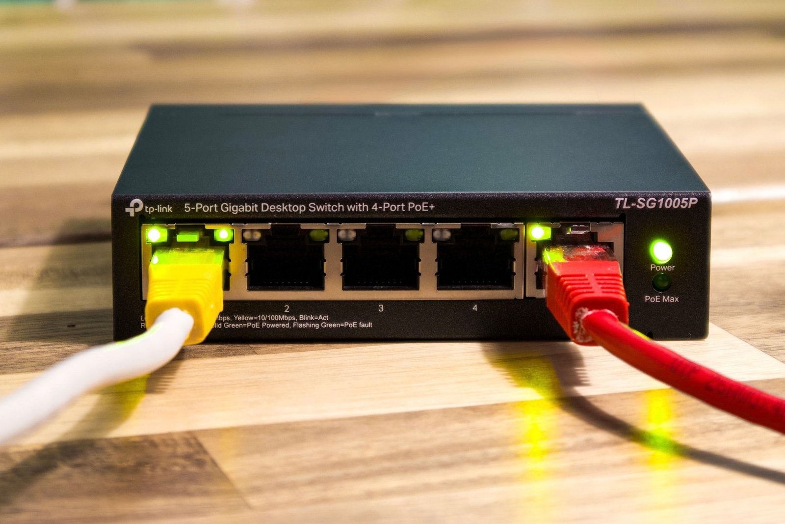 A small PoE network switch with patch cables plugged in